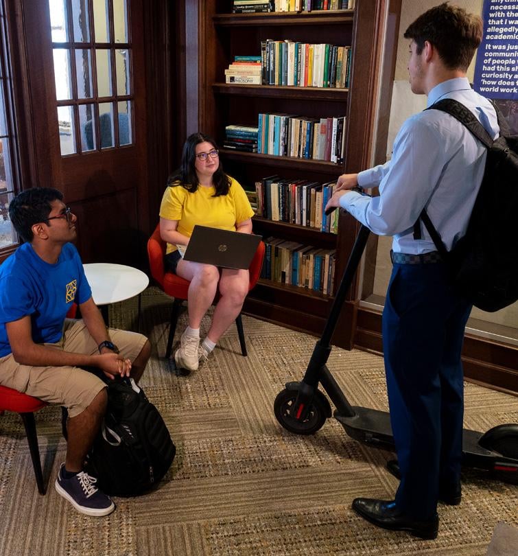 Students have a discussion in one of the Honors College's lounges.