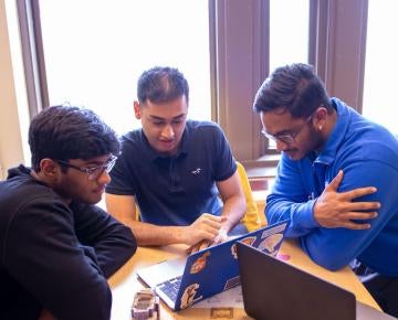 Students studying at table together