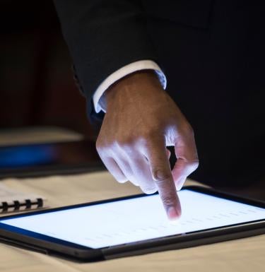 A finger points to a spot on a notepad