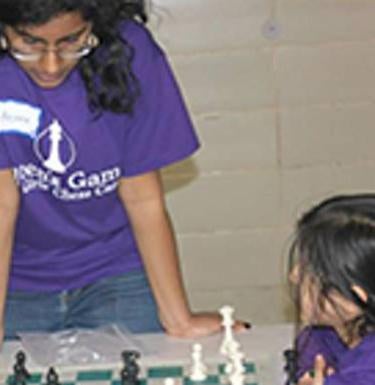 Teaching young girls chess as part of community service (ACT) research.