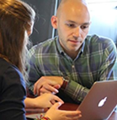 People looking at a computer