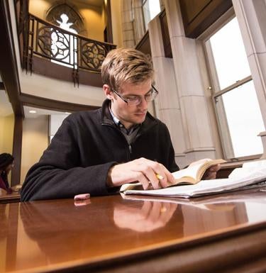 A student studies at a desk in the Honors College. 