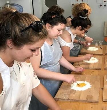 A group of students making pasta