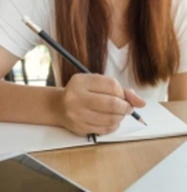 Person writing on paper