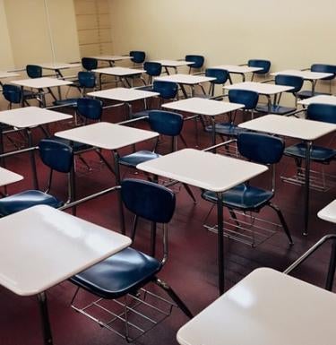 Classroom full of desks with blue chairs