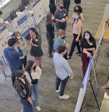 Students talking about their projects at the 2022 FHC Research Symposium
