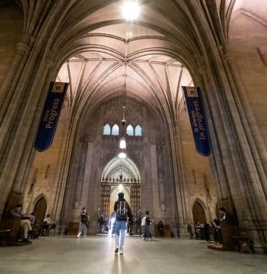 Student walking through the Common Room of Pitt's Cathedral of Learning