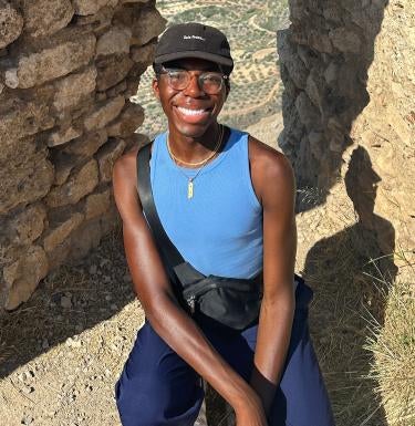 Alex-Jaden Peart in front of ancient building structure.