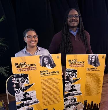 Selam Mekbeb-Gillett (left) and Ron Idoko (right) show poster boards featuring their accomplishments at A Night of Celebration: Honoring Local Heroes of Black Resistance