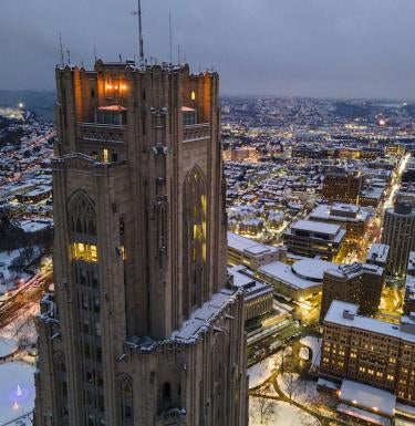 Cathedral of Learning at night with snow