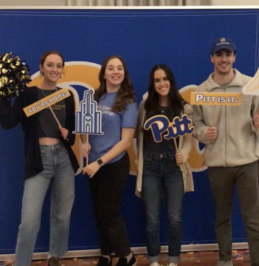 Four Frederick Honors student ambassadors showing off Pitt pride at recruitment event