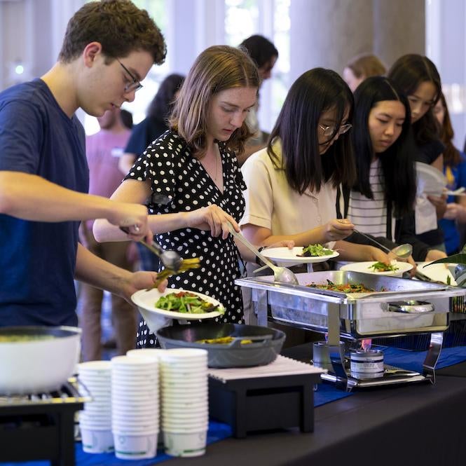 Students grab food at a carbon-tracked buffet for the 2022 Sustainability Supper hosted by the ScholarCHEF scholar community.
