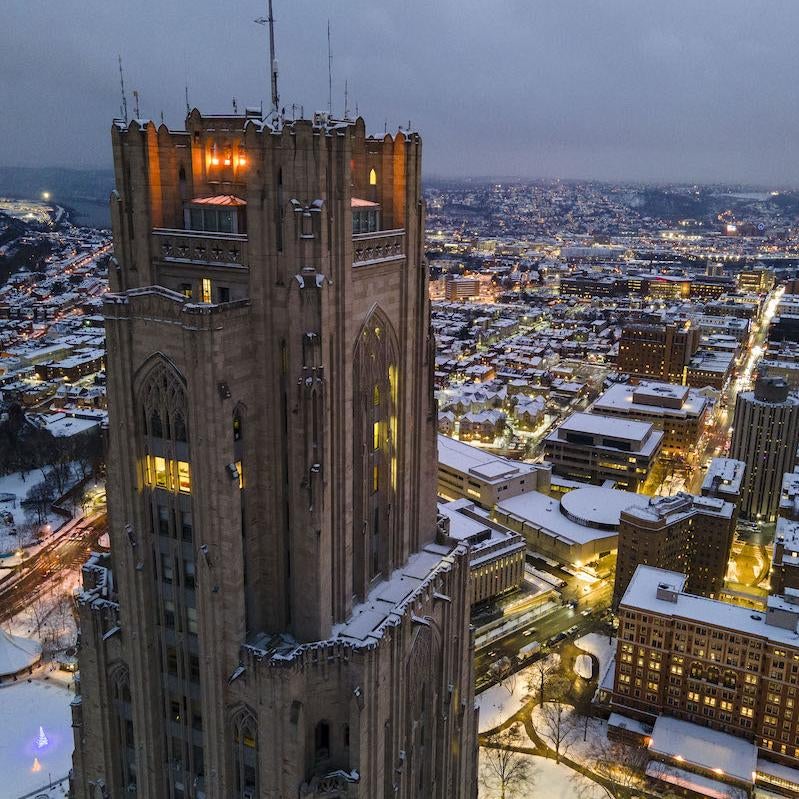 Cathedral of Learning at night with snow